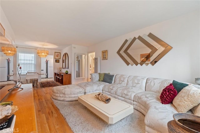 living room with an inviting chandelier and wood-type flooring