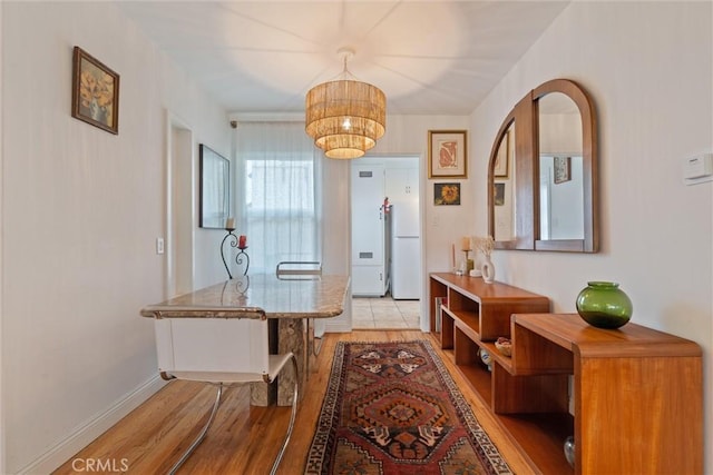 corridor with light hardwood / wood-style flooring