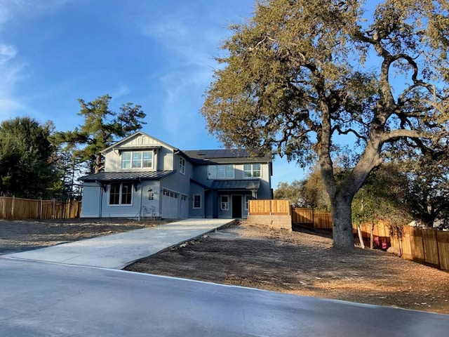 view of front of property featuring a garage and solar panels