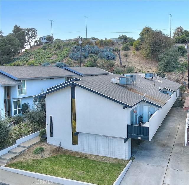 view of side of home featuring cooling unit