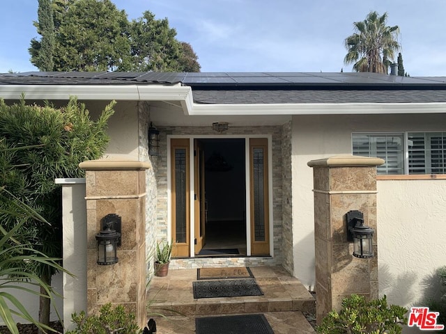 entrance to property featuring solar panels