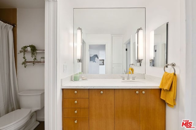 bathroom with vanity and toilet