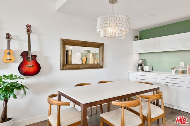 dining area featuring dark wood-type flooring and a notable chandelier