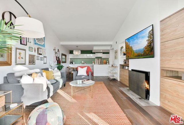 living room with wood-type flooring and vaulted ceiling