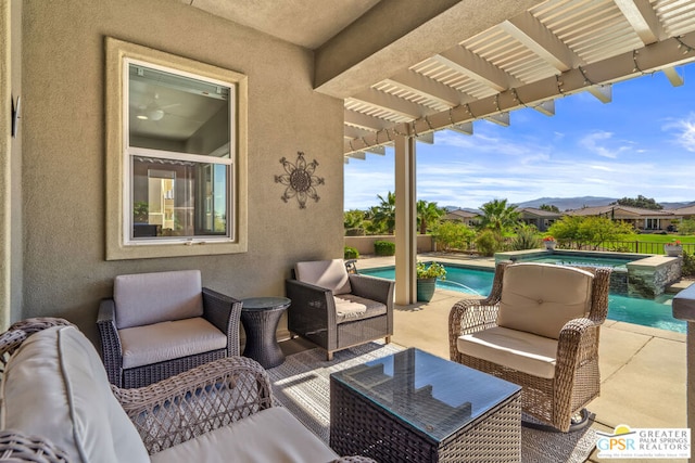 view of patio / terrace with an outdoor living space and a pool with hot tub