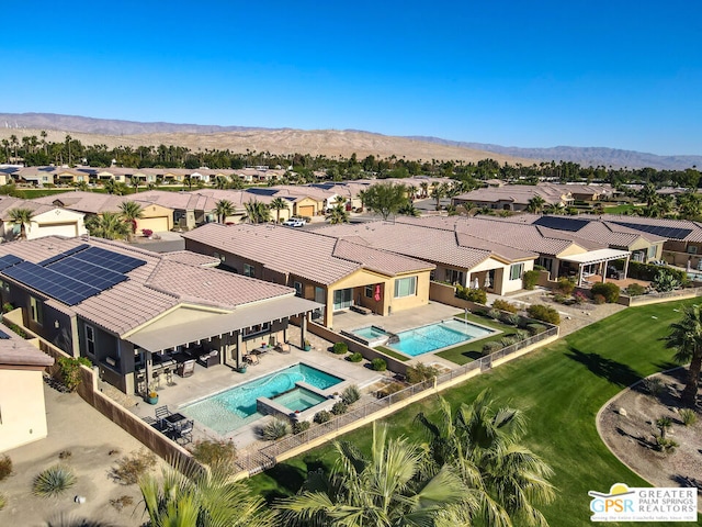 birds eye view of property with a mountain view