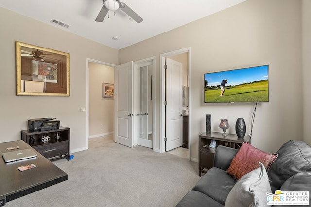 office featuring ceiling fan and light carpet