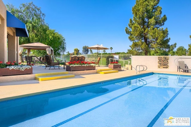 view of swimming pool with a gazebo and a patio