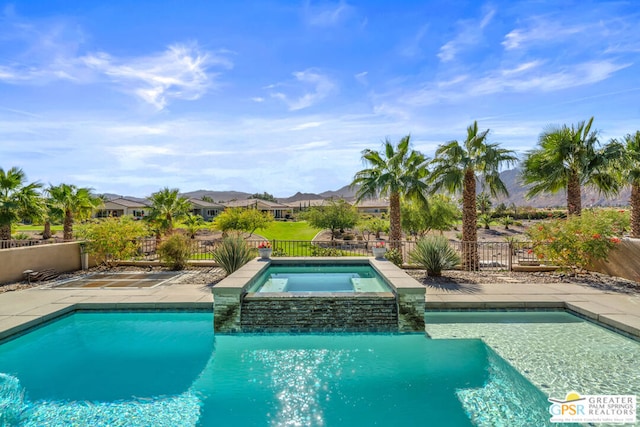 view of swimming pool featuring an in ground hot tub