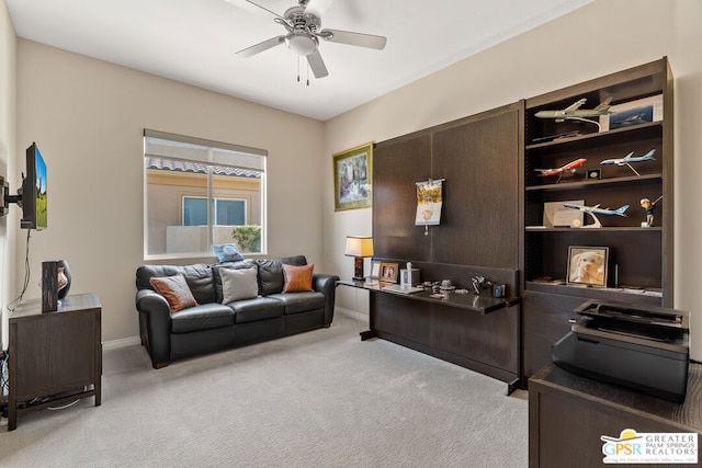 office area featuring light carpet and ceiling fan