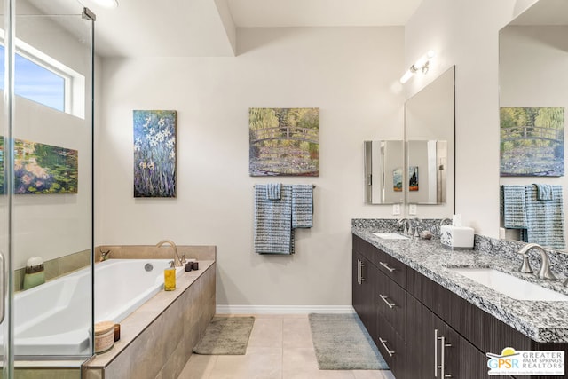 bathroom with tile patterned floors, a relaxing tiled tub, and vanity