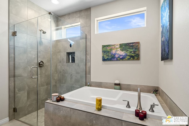 bathroom featuring separate shower and tub