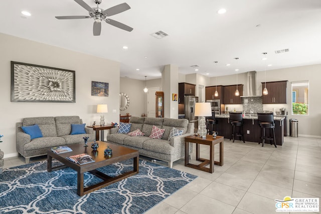 tiled living room with ceiling fan