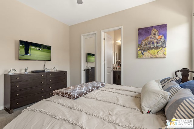 bedroom with carpet flooring, ceiling fan, and ensuite bath