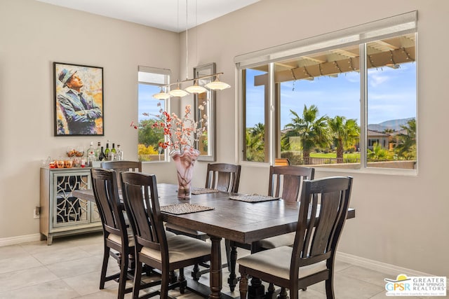 tiled dining area featuring a mountain view and a wealth of natural light