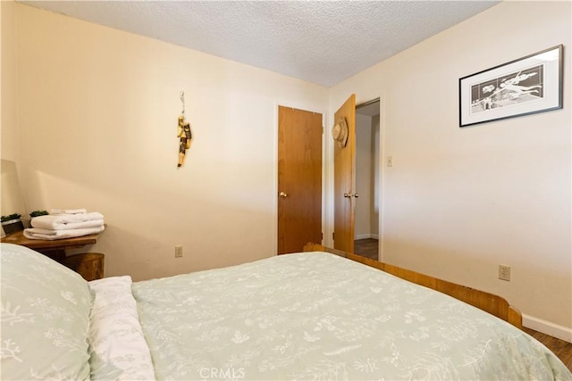 12755 Blue Heron Ct, Clearlake Oaks, CA 95423 - bedroom featuring hardwood / wood-style floors and a textured ceiling