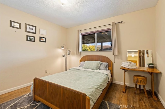 12755 Blue Heron Ct, Clearlake Oaks, CA 95423 - bedroom featuring dark wood-type flooring and a textured ceiling