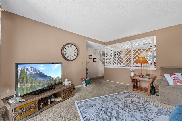 carpeted living room featuring a textured ceiling