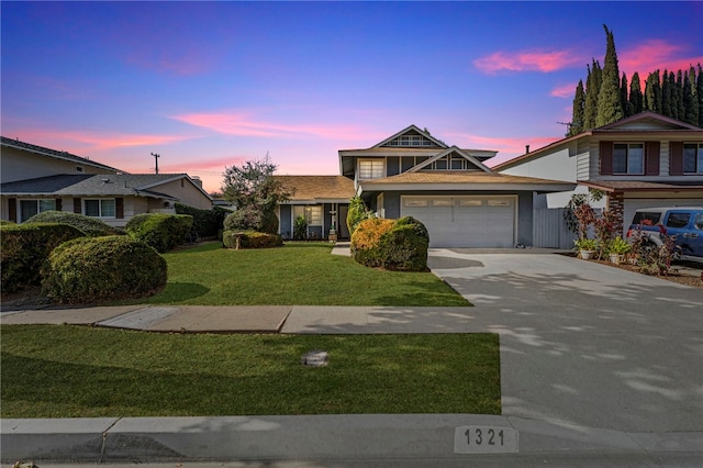 view of front of house with a garage and a lawn