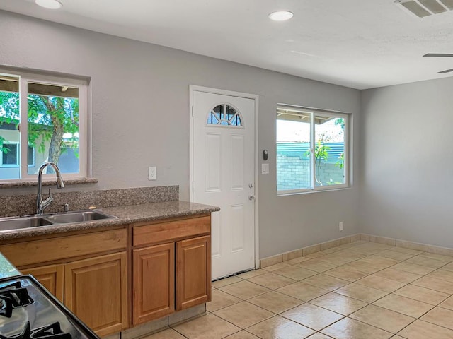 kitchen with ceiling fan, sink, and light tile patterned floors