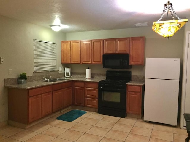 kitchen with black appliances, light tile patterned flooring, and sink