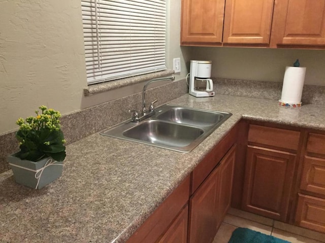 kitchen featuring sink and tile patterned flooring