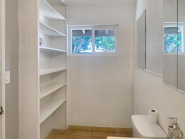 bathroom with tile patterned flooring and toilet