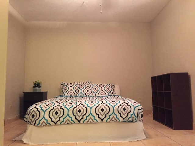 bedroom with light tile patterned floors