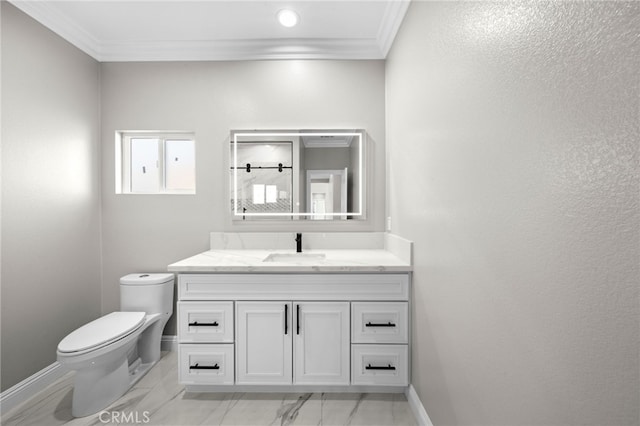 bathroom with vanity, toilet, and ornamental molding