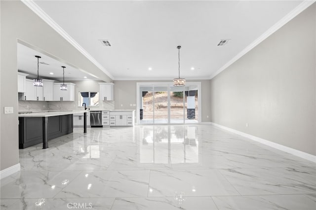 unfurnished living room featuring crown molding, sink, and a notable chandelier