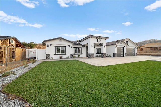 back of house with a garage and a yard