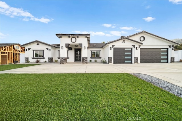 mediterranean / spanish house featuring a front yard and a garage