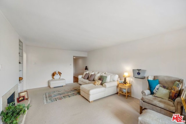 carpeted living room featuring a fireplace