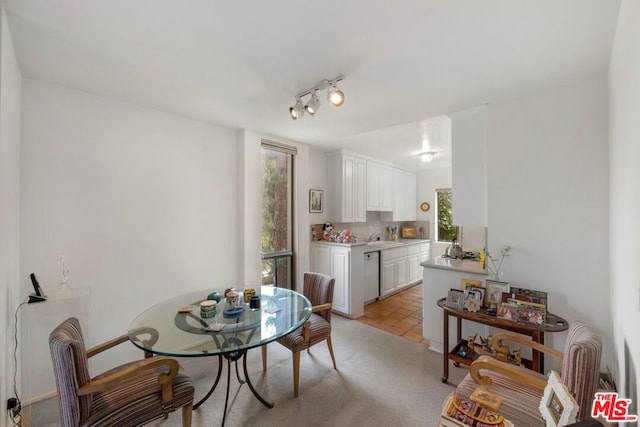 dining area with light tile patterned floors and sink