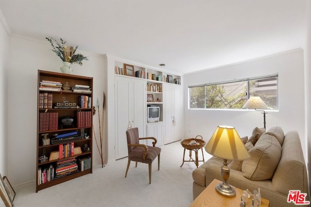 sitting room featuring light colored carpet and crown molding