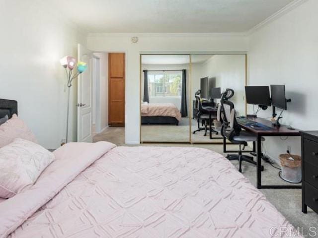 bedroom with crown molding, a closet, and carpet