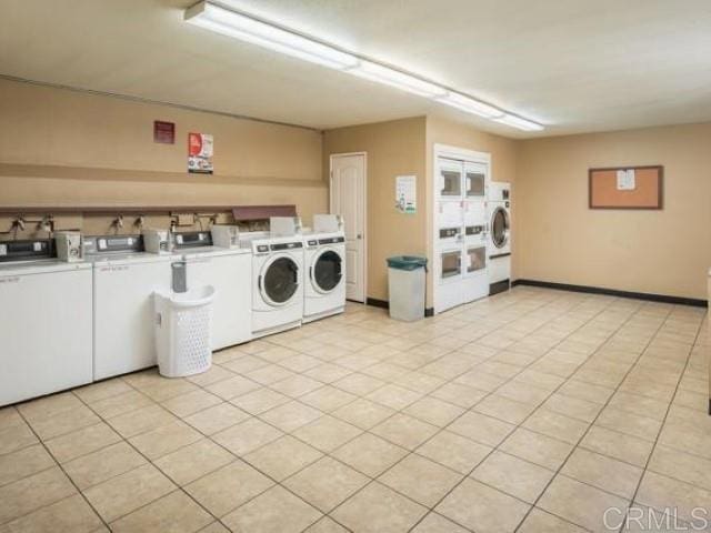 community laundry room with washing machine and clothes dryer and stacked washer / drying machine