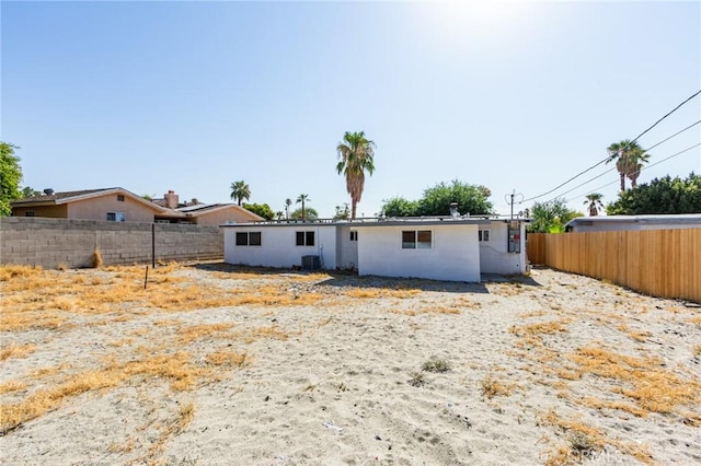 back of property with central AC unit