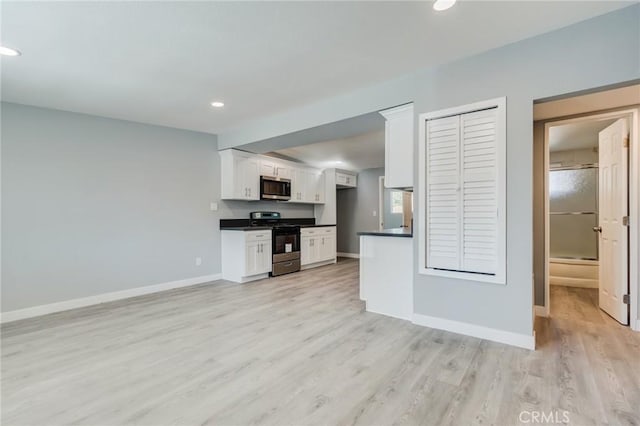 kitchen featuring white cabinetry, stainless steel appliances, and light hardwood / wood-style flooring