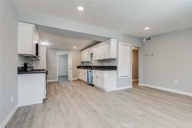 kitchen featuring dishwasher, white range, light hardwood / wood-style flooring, and white cabinetry