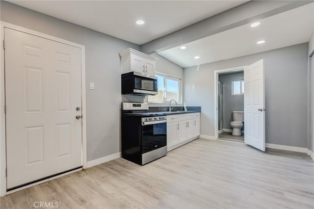 kitchen featuring white cabinets, stainless steel appliances, light hardwood / wood-style floors, and sink