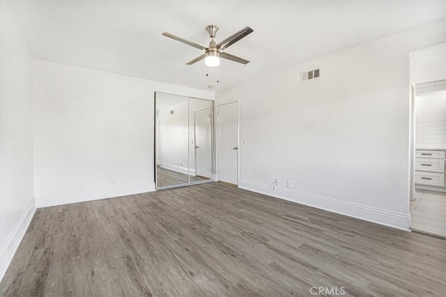 interior space featuring ceiling fan and dark hardwood / wood-style floors