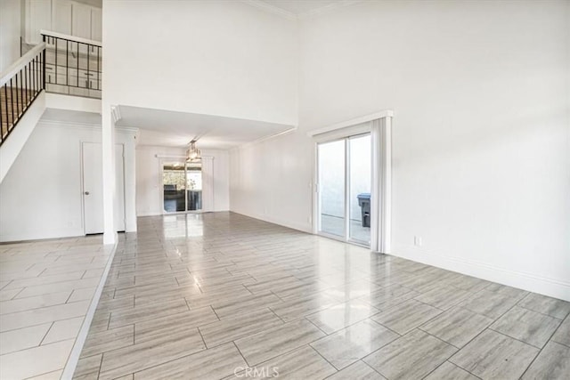 unfurnished living room with a towering ceiling