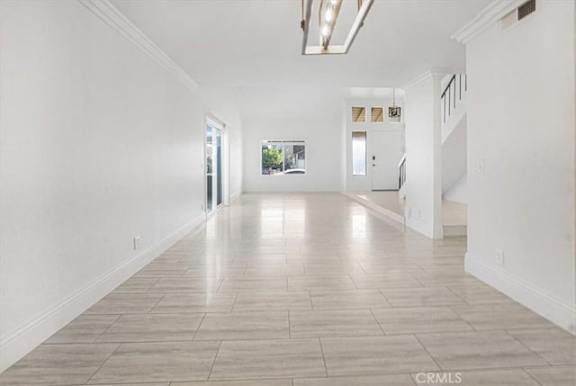 corridor with crown molding and a chandelier