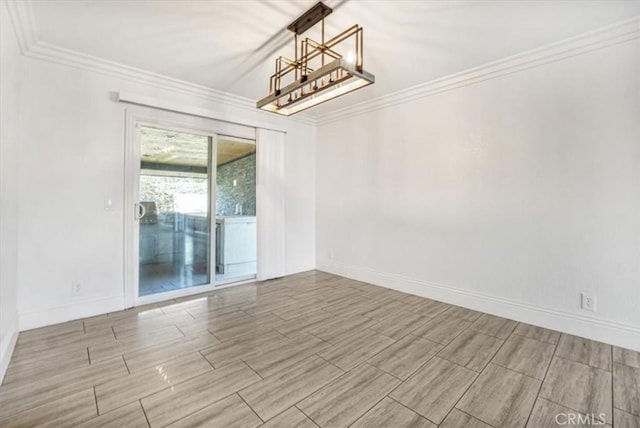 empty room featuring ornamental molding and a notable chandelier