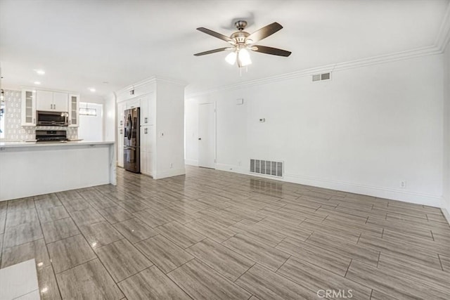 unfurnished living room with ceiling fan and ornamental molding