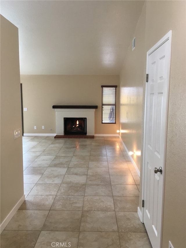 unfurnished living room featuring light tile patterned floors