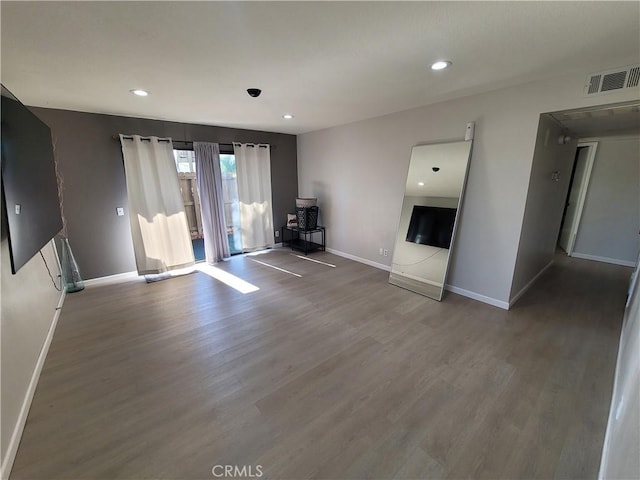 unfurnished living room with wood-type flooring and a fireplace