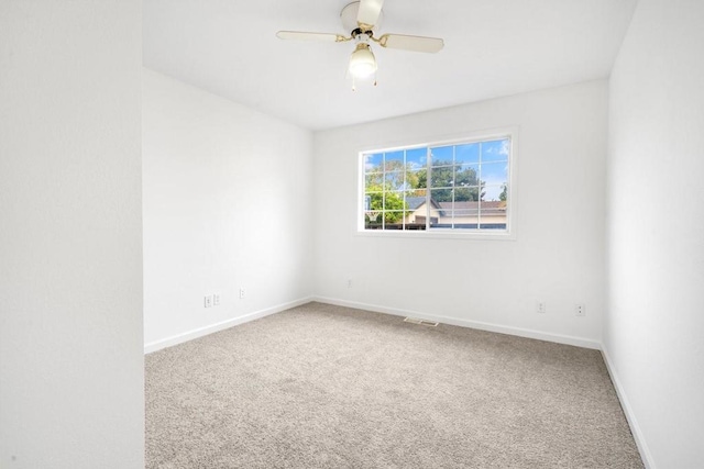 unfurnished room featuring ceiling fan and carpet floors