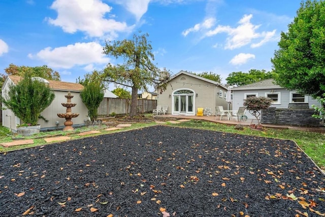 view of yard featuring french doors and a patio